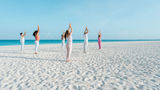 Yoga sessions alonside the crystal-clear Caribbean is one of the activities available as part of Bucuti & Tara Beach Resort's Regenerative Tranquility Package.