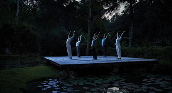 Guests participate in a Full Moon Yoga session at the Four Seasons Bali at Sayan.