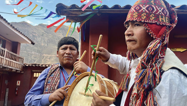 Peruvian men play music on traditional Andean instruments at the G Adventures-supported Parwa Community Restaurant.