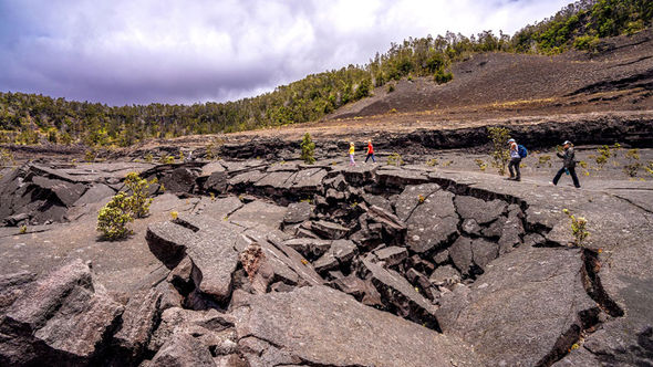 Kilauea Iki hikers cross the crater floor at Hawaii Volcanoes National Park.