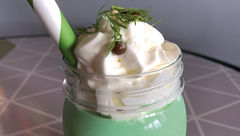 The Pickle Milkshake is complete with a fresh sprig of dill atop the whipped cream. It's served in a plastic souvenir jar and costs $5.75.
